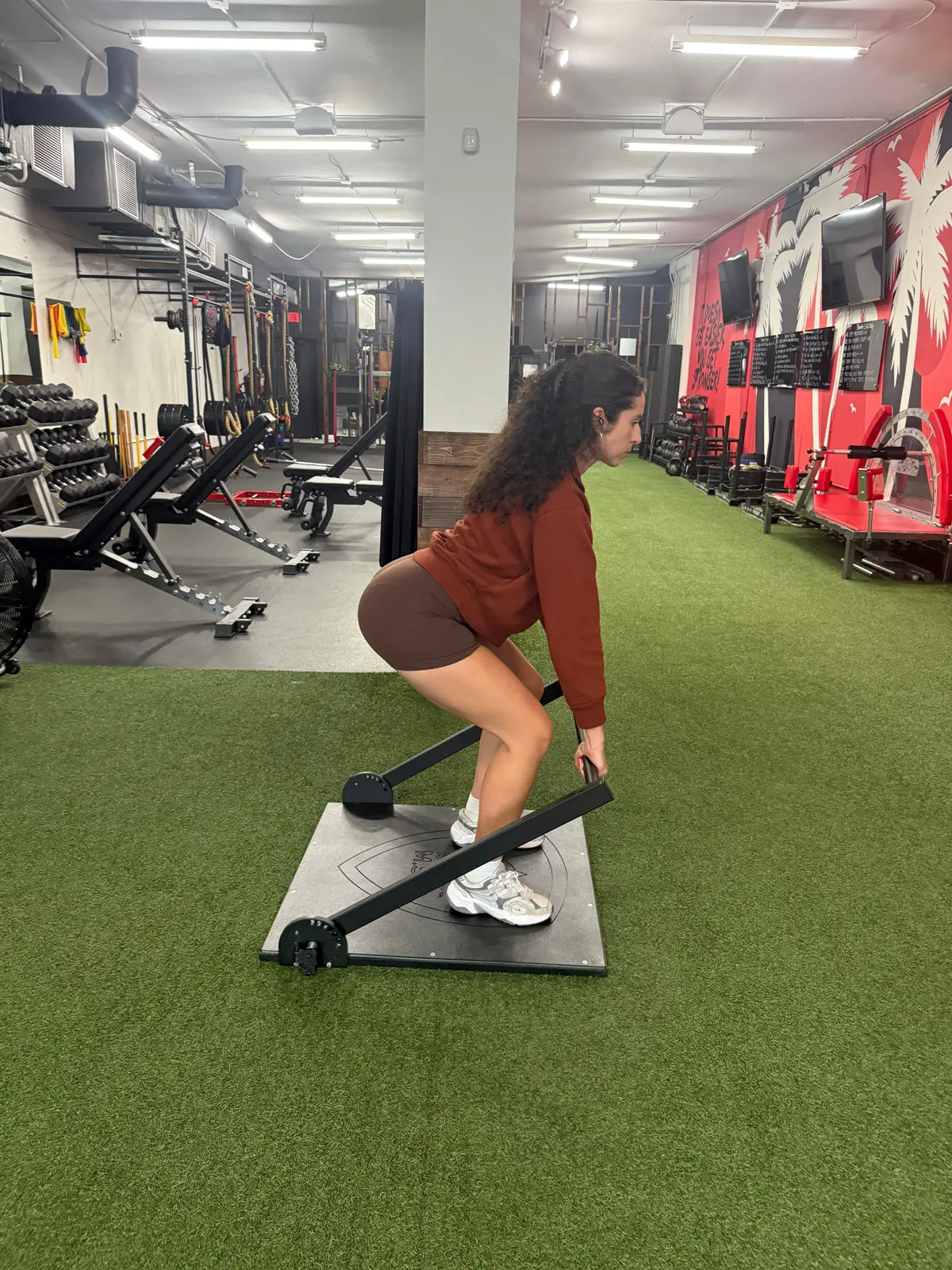 A member holds a controlled isometric pull on the ISOPHIT system at Primal Fit Miami